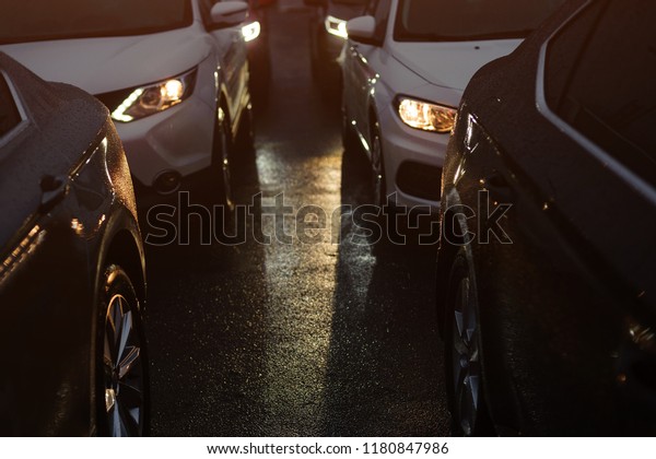 Traffic jam in the\
rainy night. Row of\
cars