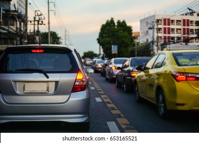 Traffic jams in the city with row of cars on the road at evening and bokeh lights in BANGKOK,THAILAND (with selective focus)