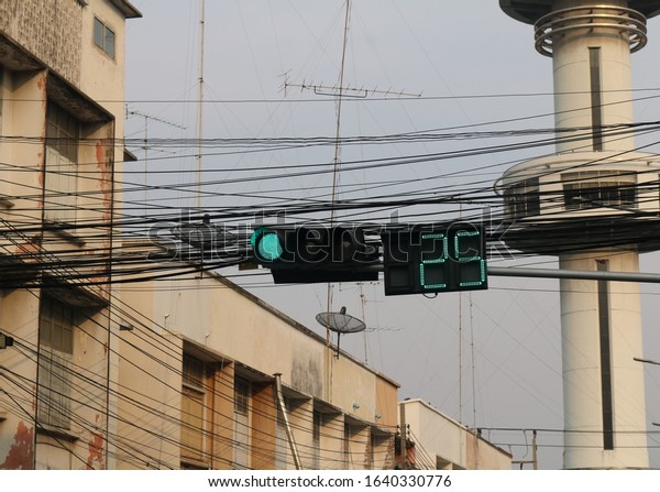 The traffic light in Asia.Traffic signal\
countdown timer. Street and traffic in\
Asia