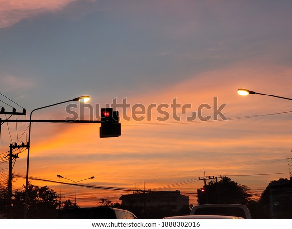 Traffic\
light with blue and yellow sky in sunset\
time