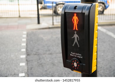 Traffic light control for pedestrians with bright red man illuminated at a pedestrian crossing