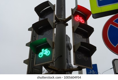 A traffic light for cyclists at a busy intersection.