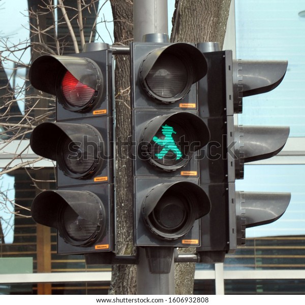 Traffic\
Light with green man with hat. Square\
photo.