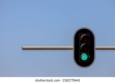 Traffic Light Hanging On The Pole With Blue Clear Sky As Background, Traffic Signals Or Stop Lights Are Signalling Devices Positioned At Road Intersections In Order To Control Flows Of Traffic.