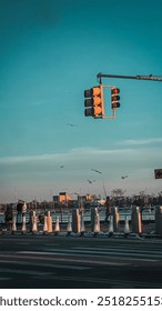 Traffic Light Hanging Over an Empty Intersection at Sunset