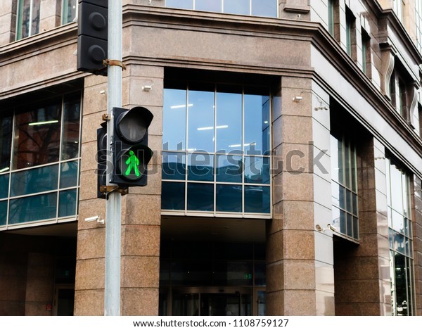 traffic light on\
the city background\
Pedestrian traffic light with the green light\
lit.\
A traffic light shows green with the background office tower.\
Focus is on the\
lights.\
