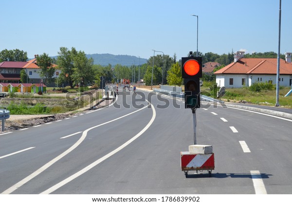 Traffic light on the road, warning for road\
under construction