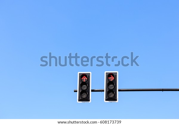 Traffic light\
with red light against the blue\
sky