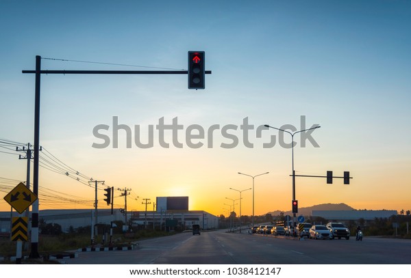 Traffic\
light with red light against the evening\
sky
