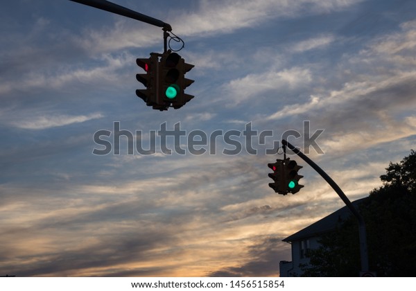 Traffic light with red light against the\
evening sky with sunset.  Selective\
focus.