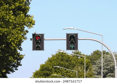 Traffic light and street lamps in a tree-lined avenue. - Powered by Shutterstock