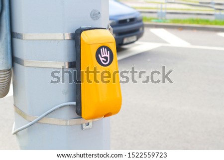 Traffic light switch button at a pedestrian crossing. You need to put your hand to the device to go.