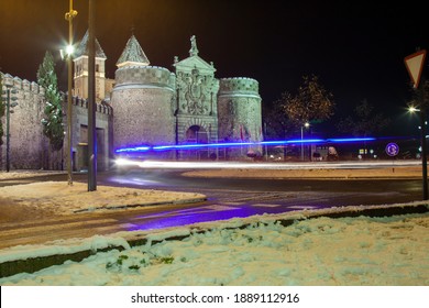 Traffic Light Trails By Night In A Snowy Day At The Puerta De Bisagra (Gate Of Bisagra) In Toledo, Spain. Long Exposure Shot.