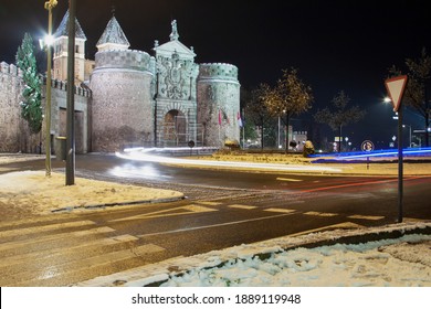 Traffic Light Trails By Night In A Snowy Day At The Puerta De Bisagra (Gate Of Bisagra) In Toledo, Spain. Long Exposure Shot.