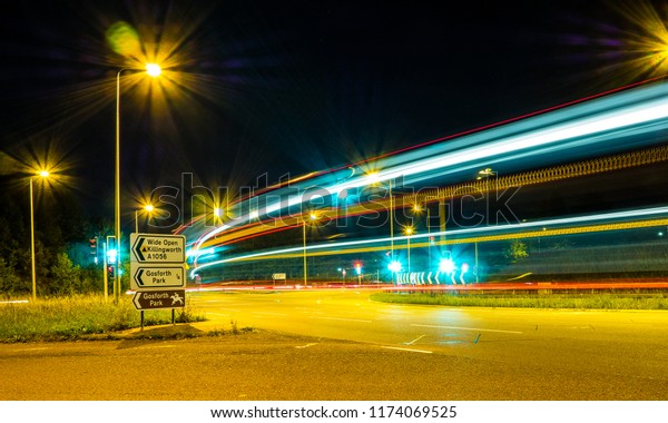 Traffic Light trails at an intersection\
at night time in Gosforth England near Newcastle\
