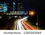 Traffic light trails from moving cars on Lamar Street in Austin, texas with buildings in the background
