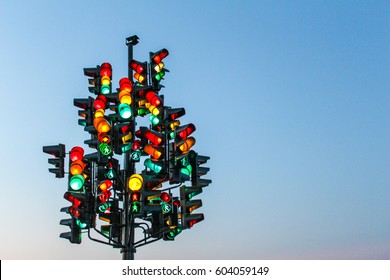 Traffic light tree with a lot of lamps under sky with a sunset. - Powered by Shutterstock