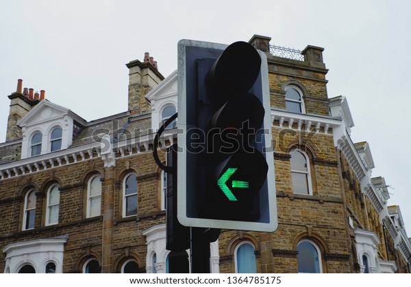 Traffic light of turn left sign with\
selective focus in Knaresborough, Yorkshire,\
England