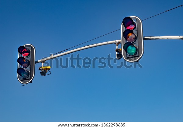 Traffic lights in Central Europe. Signal lights\
above the road. spring\
time.