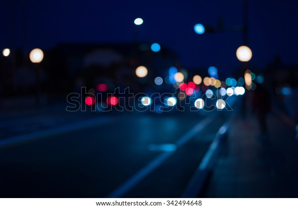 Traffic lights of the night\
city road. beautiful background of bokeh lights at night on road\
with car