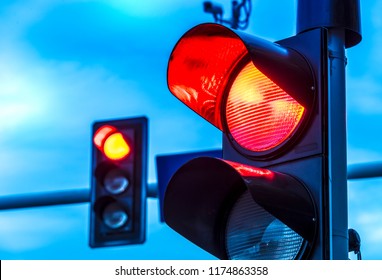 Traffic lights over urban intersection. Red light - Shutterstock ID 1174863358