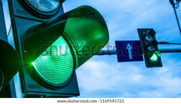 Traffic\
lights over urban intersection. Green\
light