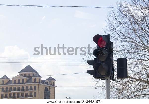 Traffic lights\
over urban intersection. Red\
light.