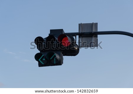 Traffic lights, red and green. A blue background.