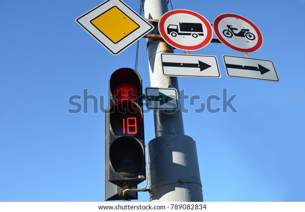 Traffic lights and road\
signs against sky