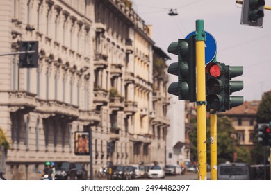 Traffic lights street in the street of Milano, Italy. Traffic light with red stop color in urban environment. Blurred building in the background.  - Powered by Shutterstock
