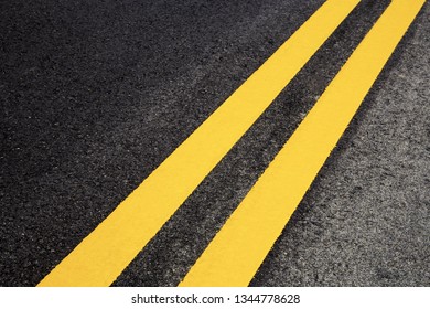 Traffic line of yellow on road with texture background.