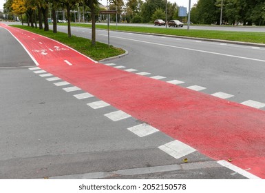 traffic, marking and city concept - red bike lane or road crossing with signs only for bicycles and two way arrows on street