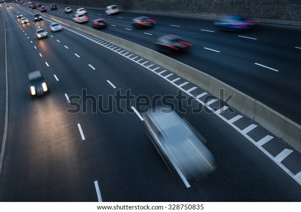 Traffic in motion on highway
at dusk