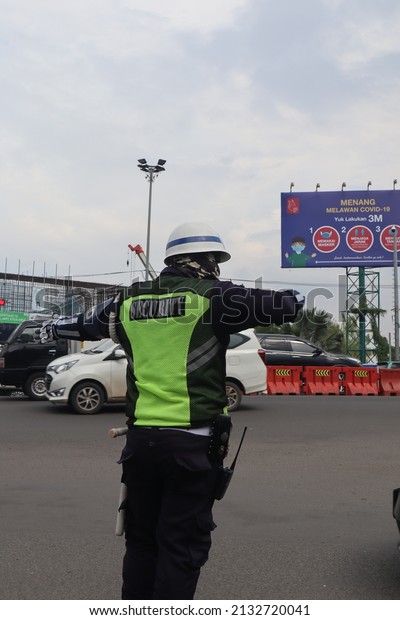 traffic officer on duty manage the city street.\
Bekasi, Indonesia. October 11th\
2019