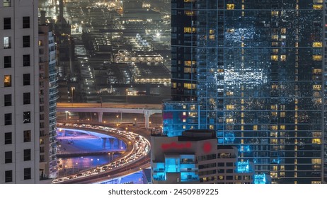 Traffic on the bridge at JBR and Dubai marina aerial night timelapse. Illuminated modern towers and skyscrapers near canal - Powered by Shutterstock