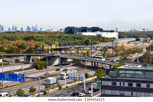 Traffic on busy highway (autobahn)\
and Frankfurt skyline in distance - Frankfurt, Germany\
