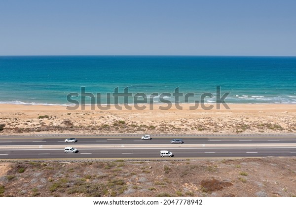 Traffic on a\
coastal highway road, Aerial\
image.