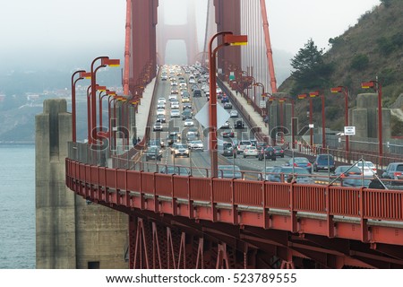 Traffic on Golden Gate Bridge in the evening with foggy