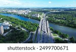 Traffic on Highway 35 Central Austin, toward South side of city urban core over Colorado River, Riverside, South River City, Travis Heights community neighborhood, boardwalk green trees, aerial. USA