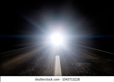 Traffic On The Highway At Night. Blinding Oncoming Car Headlights.