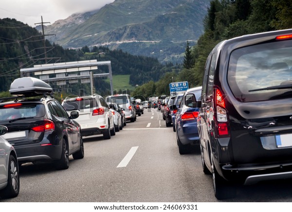 Traffic on\
the highway. Transportation. pollution, cars, rush hour, vacation,\
travel and holiday concept. Sitting in traffic on a highway in\
Switzerland driving home to\
Lucern
