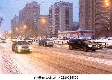 Traffic On Slippery Snowy City Road In Snowfall In Pink Winter Twilight In Moscow City