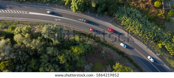 Traffic on a spanish road with cars driving seen\
from above aerial\
view	
