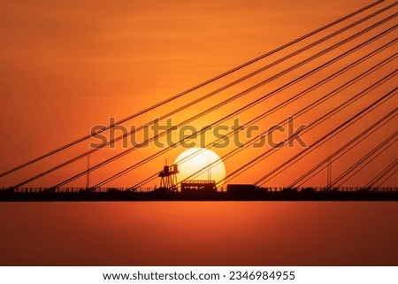Traffic on suspension bridge in Hong Kong under sunset