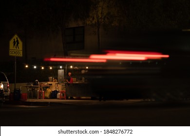 Traffic Passes A Mexican Food Stand On A Street Corner In Los Angeles, California On February 13th, 2020.
