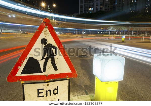Traffic passing by\
construction sign