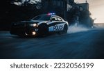 Traffic Patrol Car in Pursuit. Police Officers in Squad Car Chasing Suspect on Industrial Road, Sirens Blazing, High Speed. Cops on Emergency Response Call. Stylish Cinematic Action Packed Shot