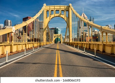 Traffic and people cross the Allegheny River on the Roberto Clemente Bridge in downtown Pittsburgh Pennsylvania USA