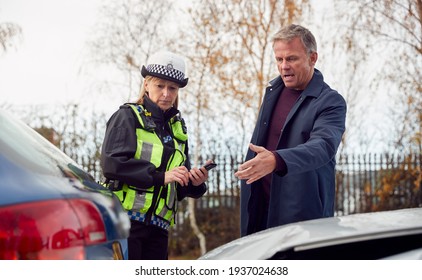 Traffic Police Officer Takes Witness Statement From Driver At Road Traffic Accident On Mobile Phone