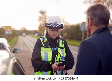 Traffic Police Officer Takes Witness Statement From Driver At Road Traffic Accident On Mobile Phone